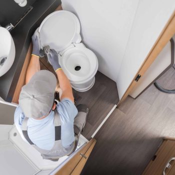 rv-rental-worker-keeping-motorhome-toilet-bowl-cle-2023-11-27-05-00-32-utc (1)